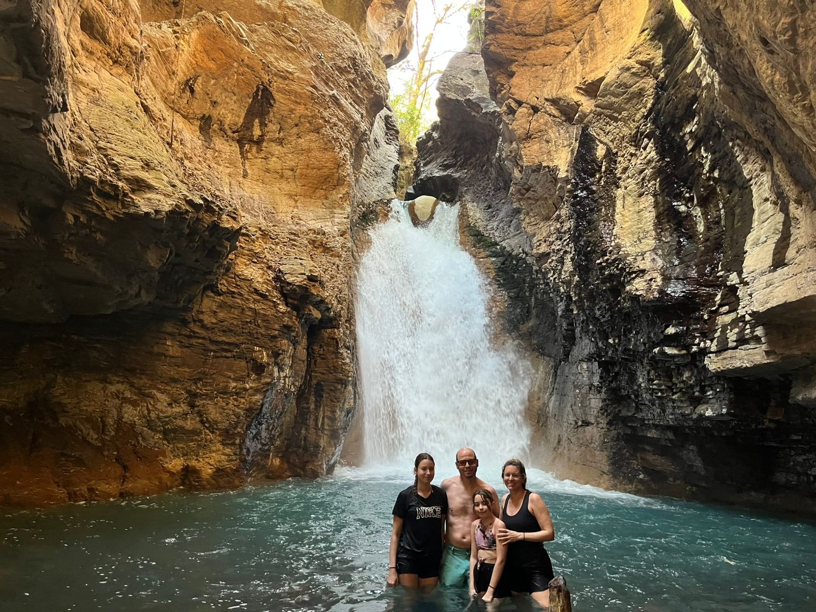 Guests swimming at La Leona Waterfall